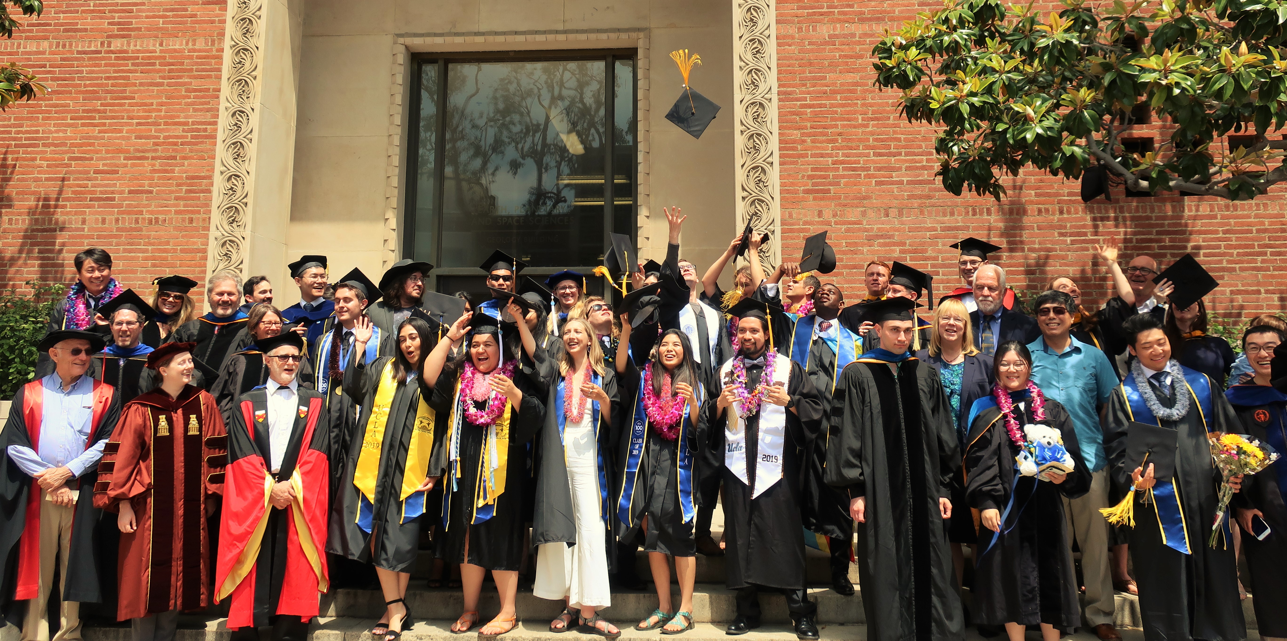 Graduates celebrate near the UCLA Geology Building.