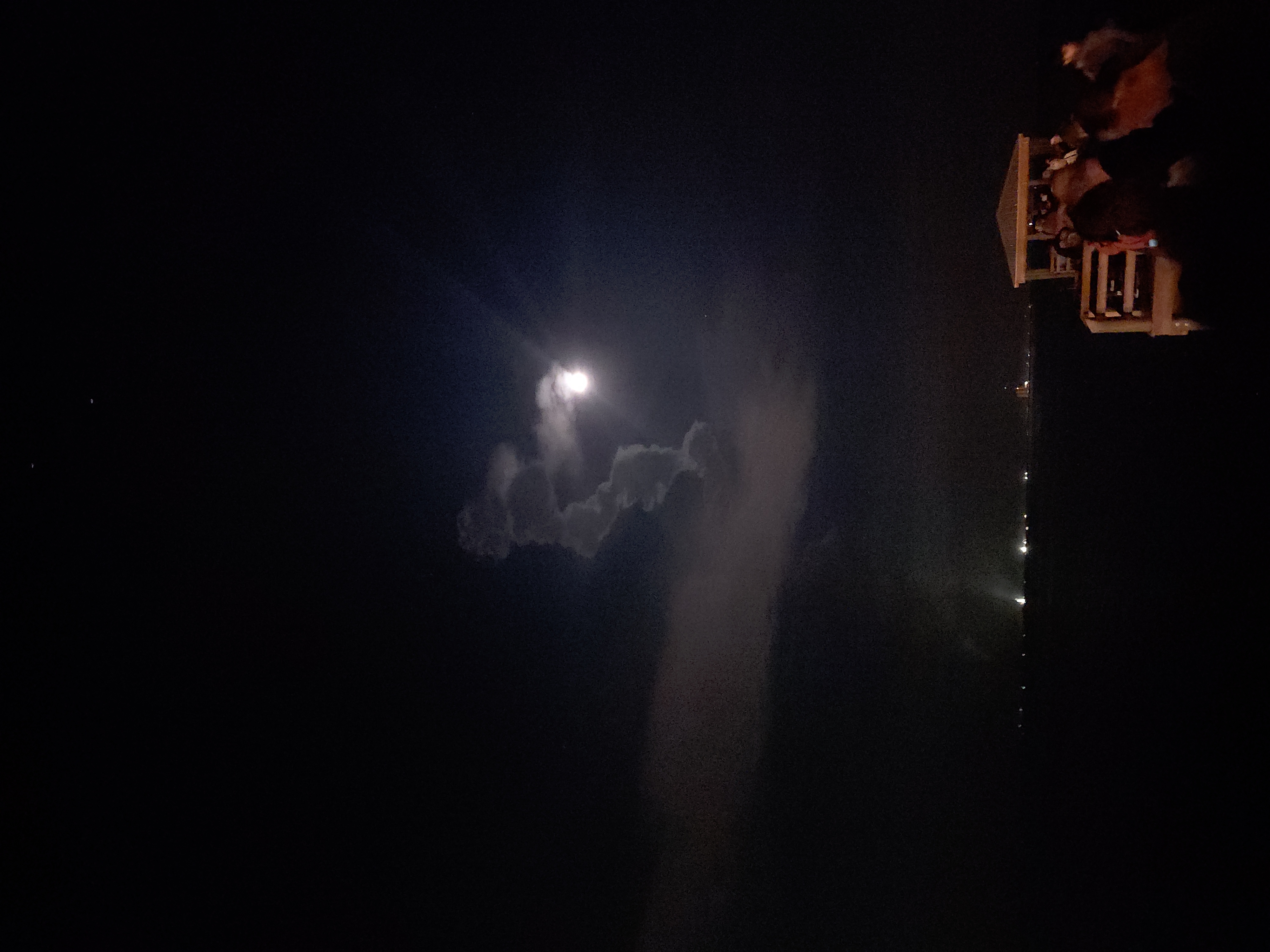 SLS rocket is a bright ball of light illuminating the dark night sky as it ascends.
